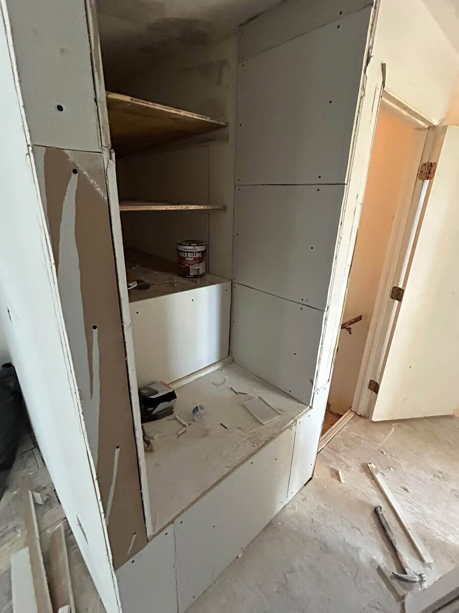 Built-in shelving and drywall installation in progress